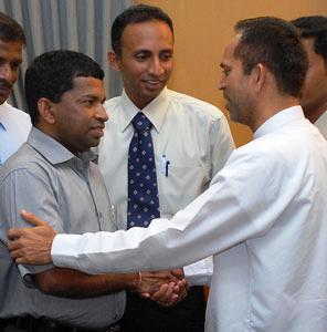 Chief Minister of the Eastern Province Mr. S. Chandrakanthan, former member of the LTTE, being congratulated on his appointment by Provincial Minister Mr. M.L.A.M. Hisbullah.